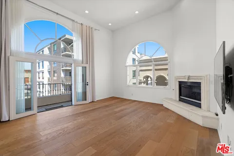 a view of an empty room with a fireplace and a window