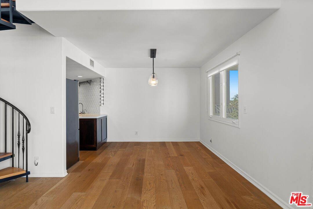 435 Arnaz Drive, Unit 304 Los Angeles, CA 90048 - Photo 9 of 21 a view of empty room with wooden floor and fan