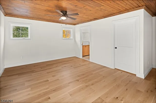 a bathroom with a granite countertop sink a toilet and a mirror