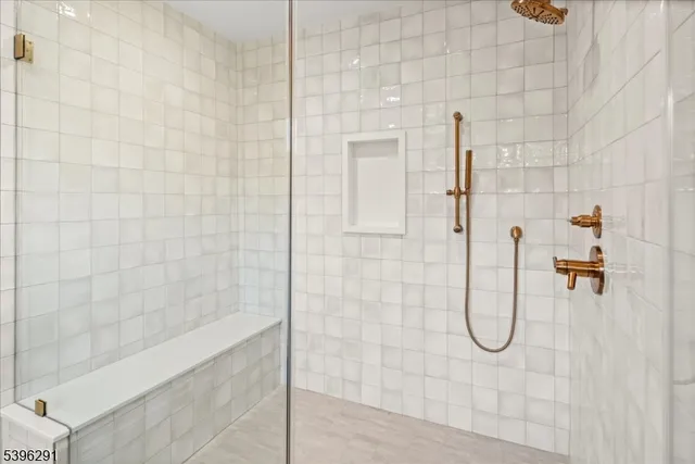 a view of a hallway that has wooden floor and a window