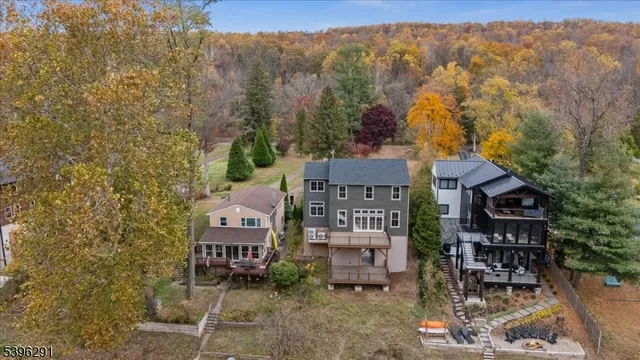 an aerial view of residential houses with outdoor space and trees