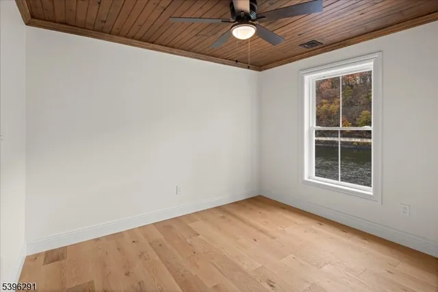 a view of a big room with windows and entryway