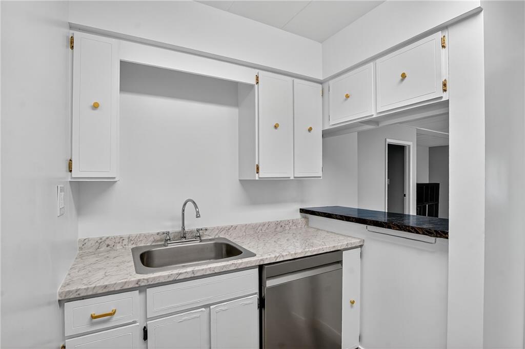 5 Bayard Road, Unit 500 Pittsburgh, PA 15213 - Photo 35 of 45 A sleek white kitchen with stainless steel accents, serves as a focal point for the kitchen, inviting for coffee or cocktails.