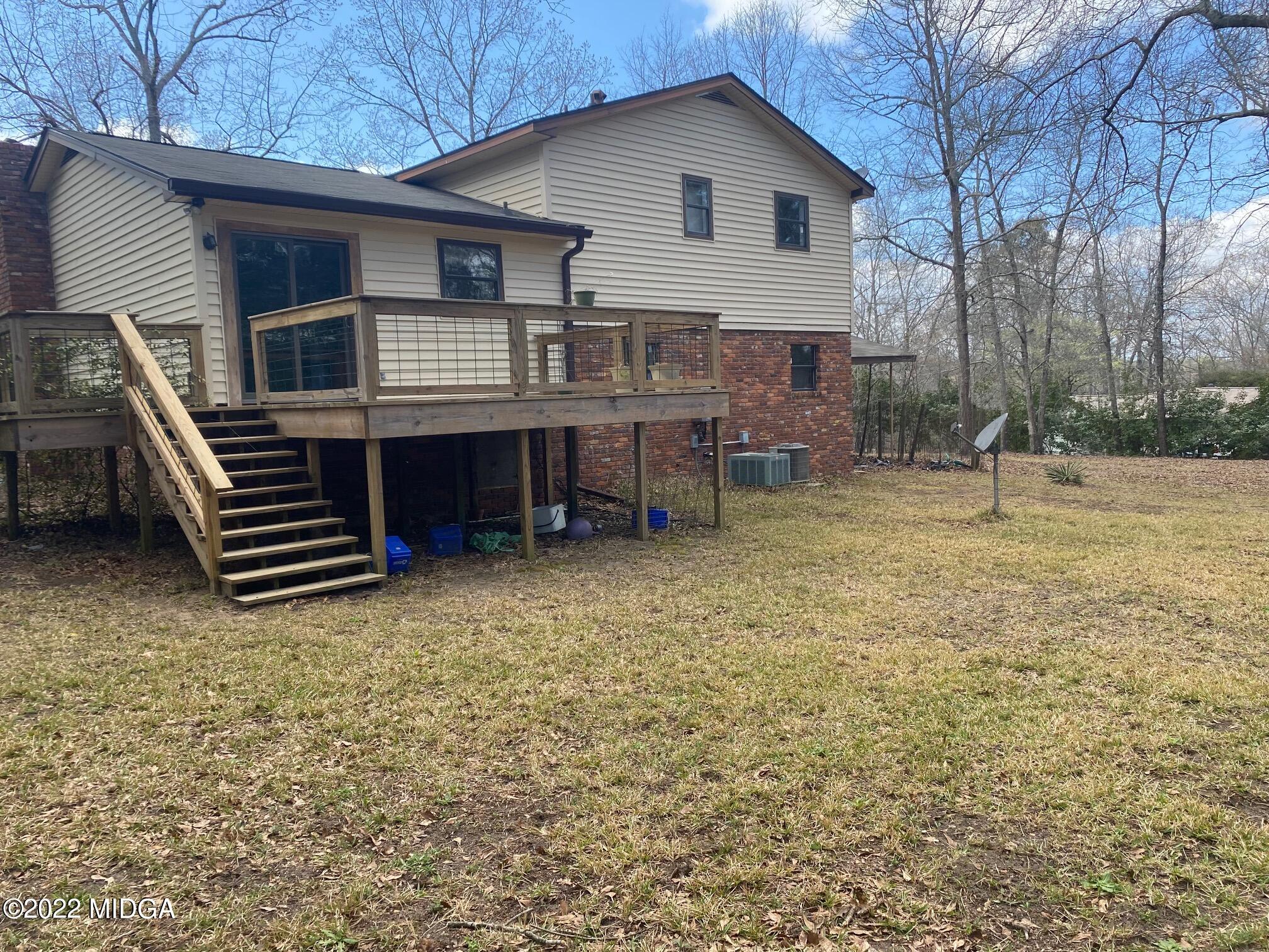 114 Pine Tree Road Macon, GA 31211 - Photo 17 of 18 a backyard of a house with table and chairs