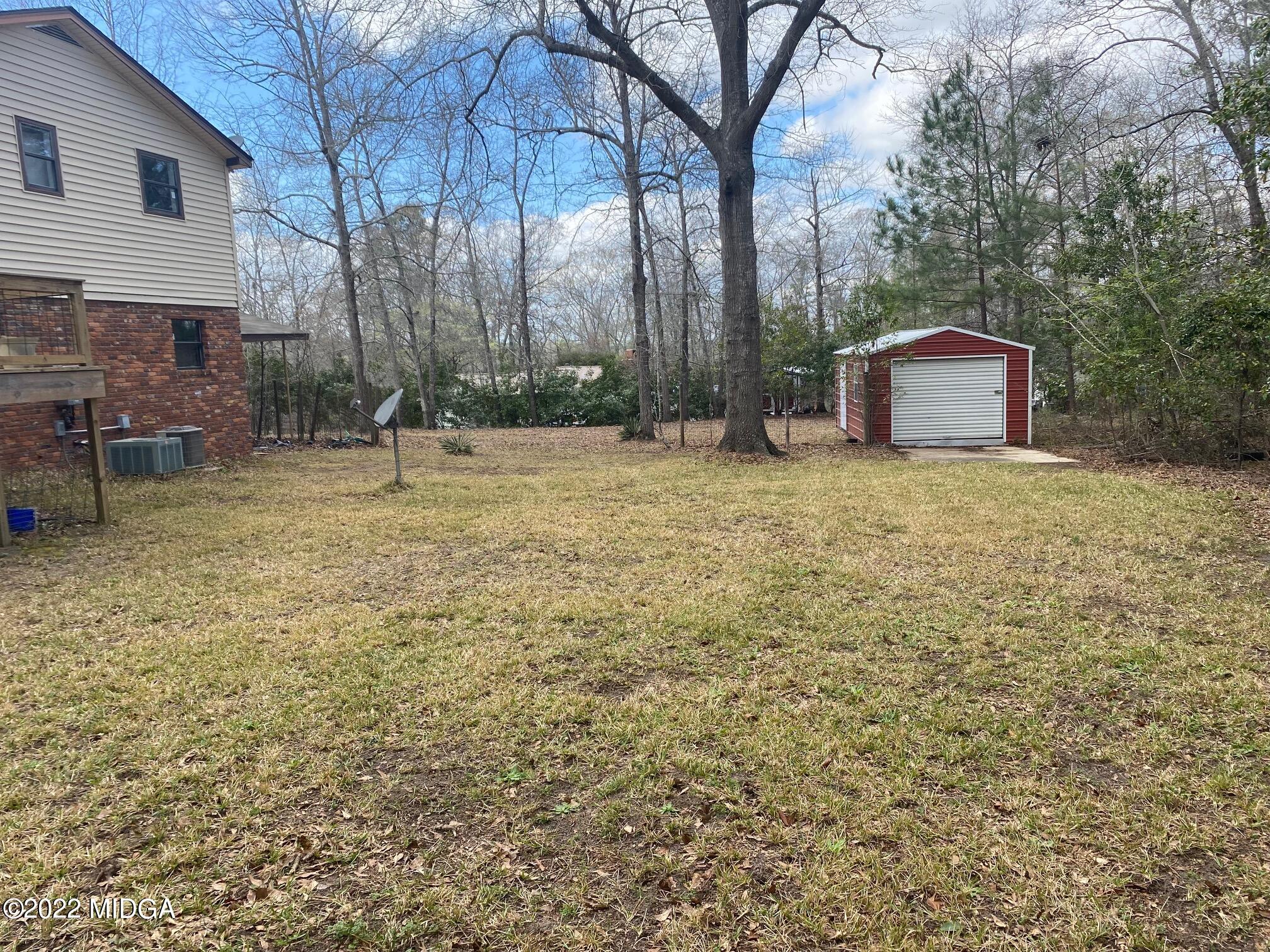 114 Pine Tree Road Macon, GA 31211 - Photo 18 of 18 a backyard of a house with a table and chairs