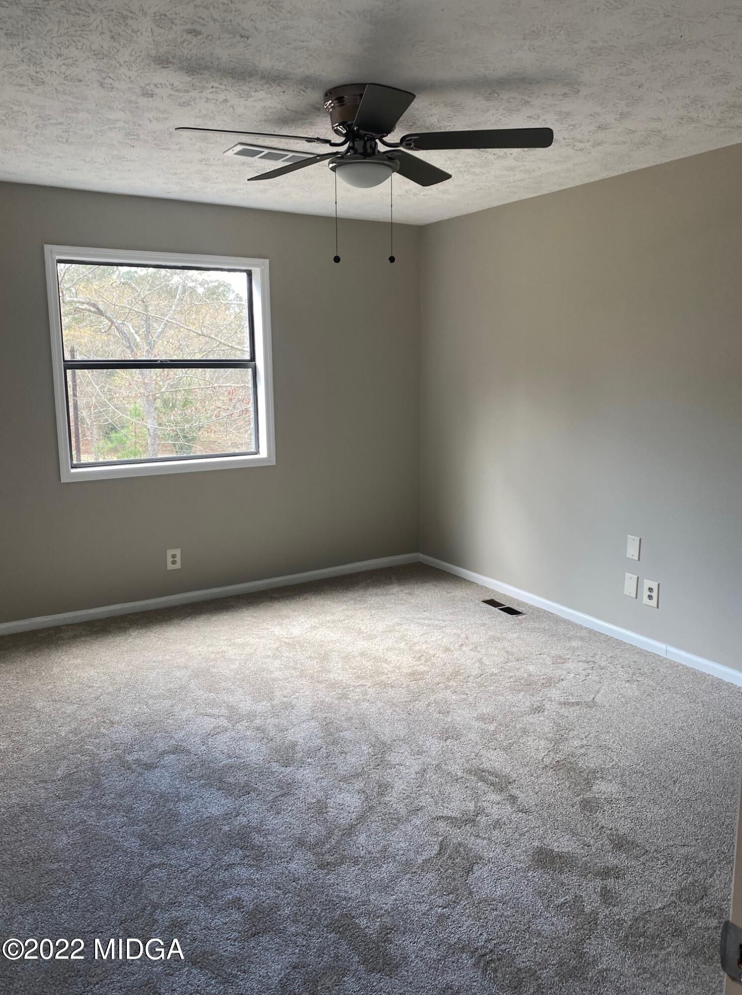 114 Pine Tree Road Macon, GA 31211 - Photo 5 of 18 a view of an empty room with a window