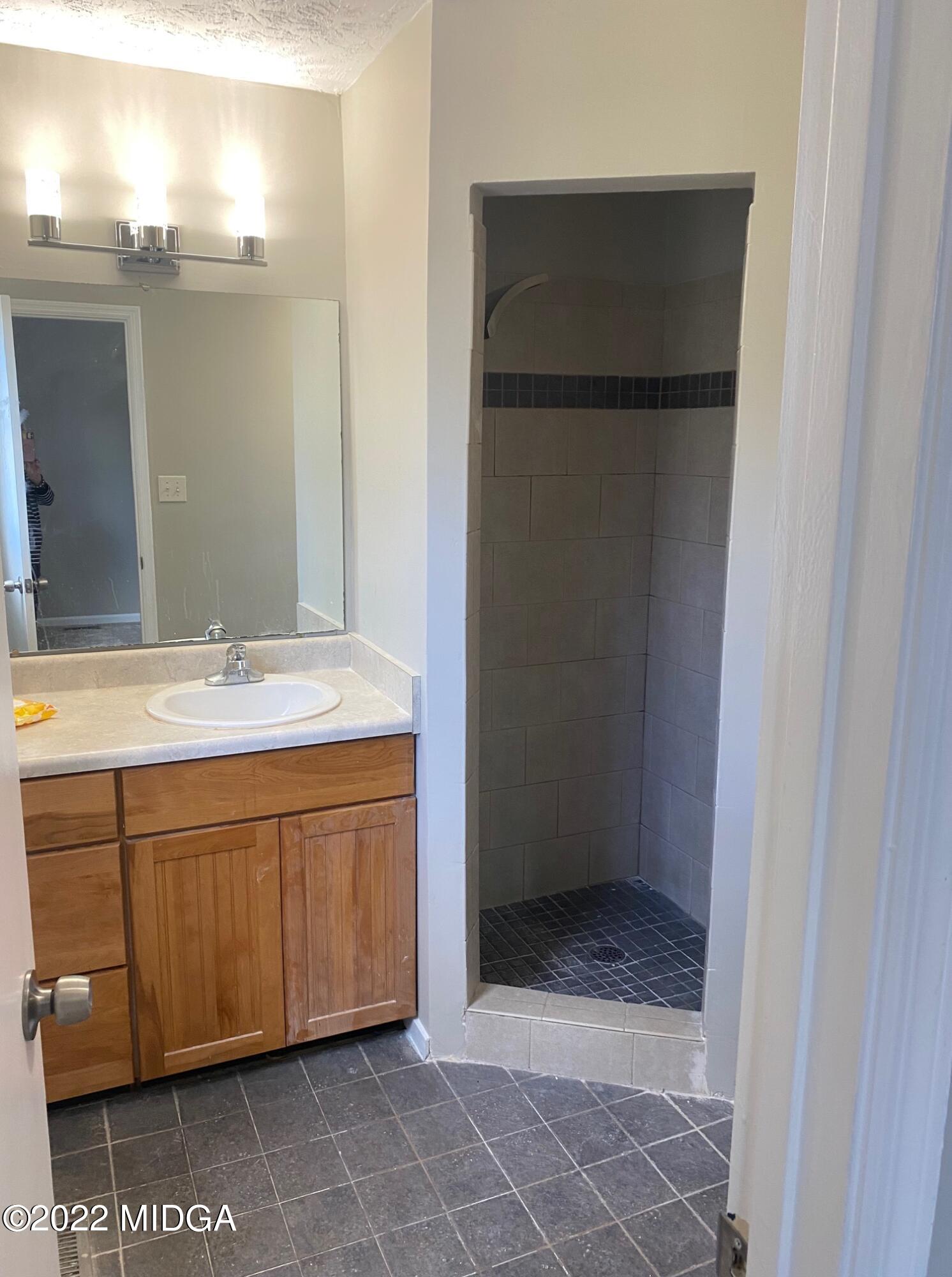 114 Pine Tree Road Macon, GA 31211 - Photo 7 of 18 a bathroom with a double vanity sink and mirror