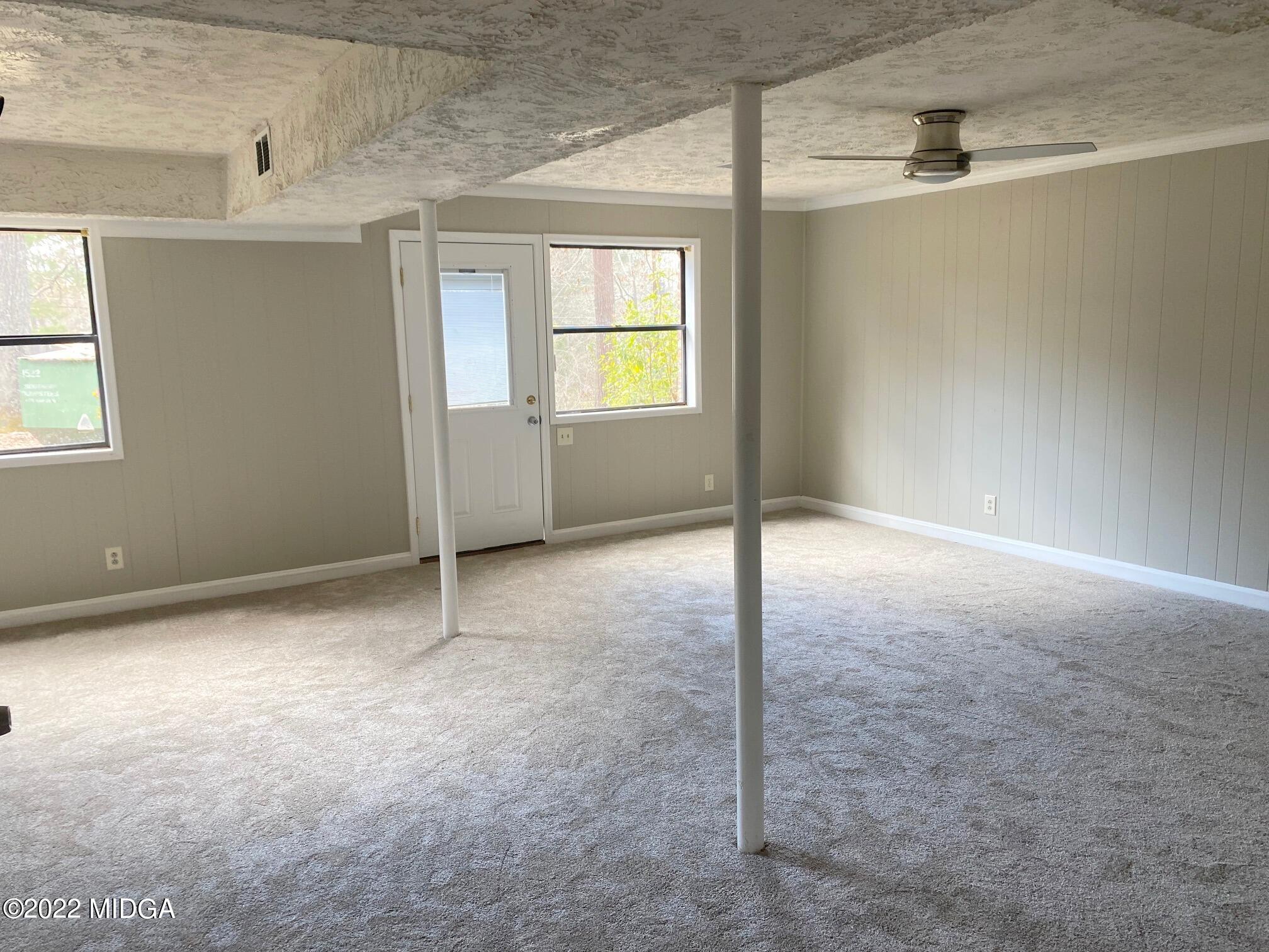 114 Pine Tree Road Macon, GA 31211 - Photo 8 of 18 an empty room with windows