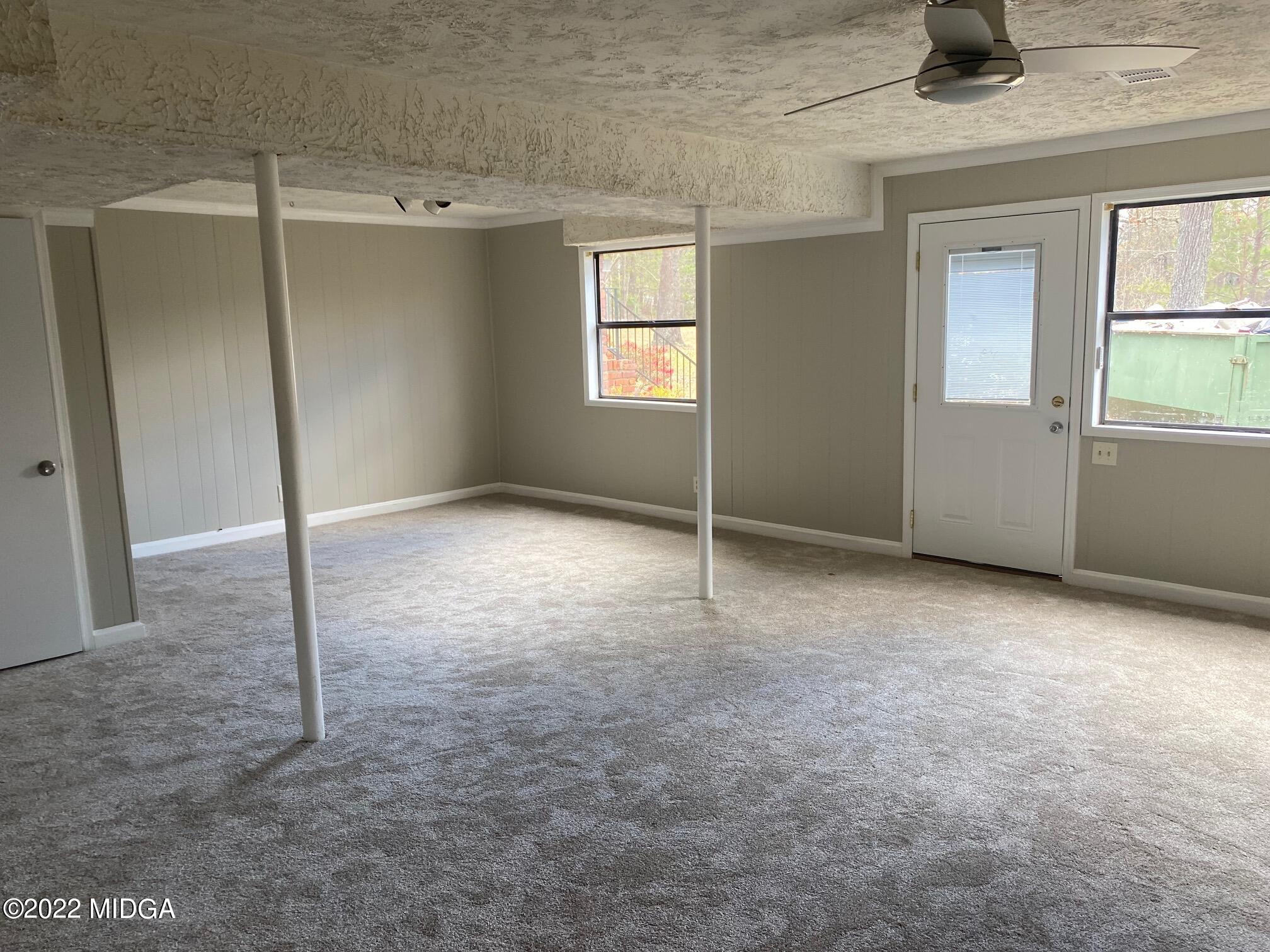 114 Pine Tree Road Macon, GA 31211 - Photo 9 of 18 an empty room with windows