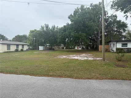 a view of a house with a yard and garage