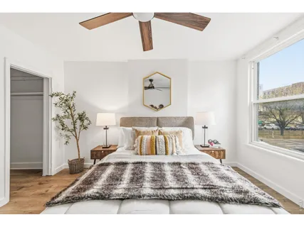 a bedroom with a bed and wooden floor