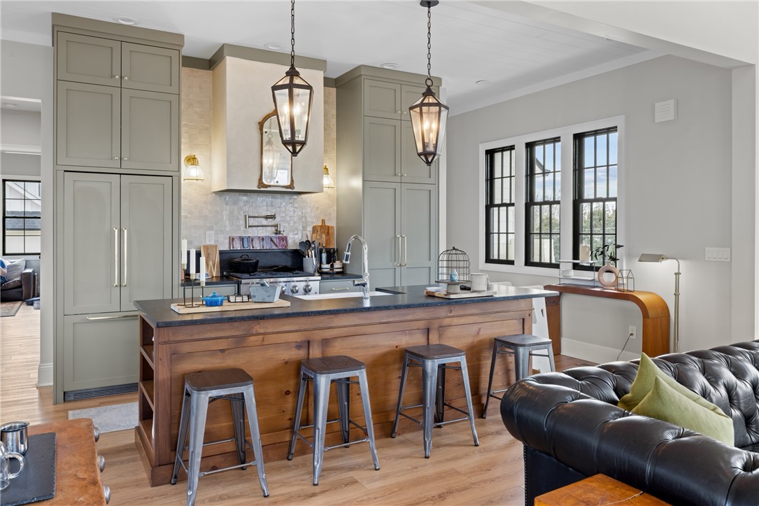 677 Lightwood Road Hartwell, GA 30643 - Photo 9 of 42 An inviting kitchen with a central island and contemporary lighting fixtures provides a warm ambiance.