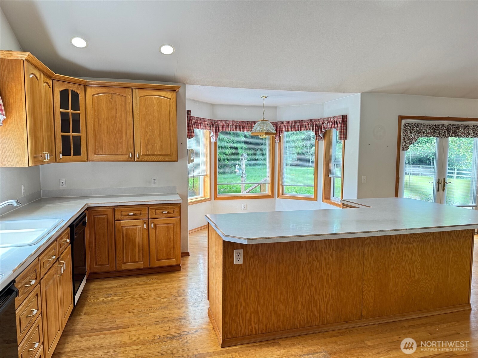 698 Logan Hill Road Chehalis, WA 98532 - Photo 12 of 35 a kitchen with kitchen island granite countertop a sink and a large window
