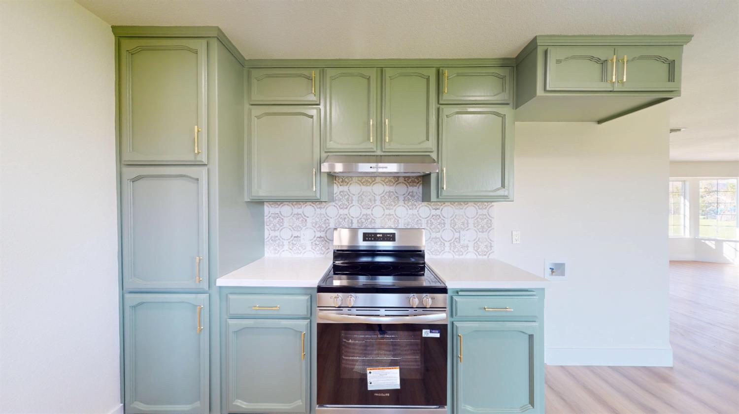 16363 Paula Road Madera, CA 93636 - Photo 7 of 29 a kitchen with a stove and a refrigerator