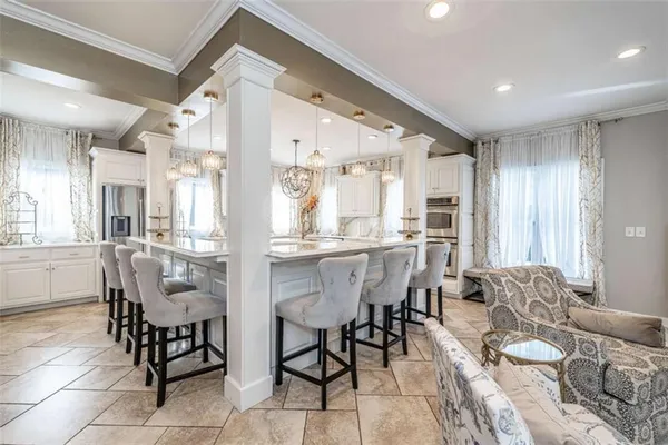 a living room with lots of furniture and chandelier