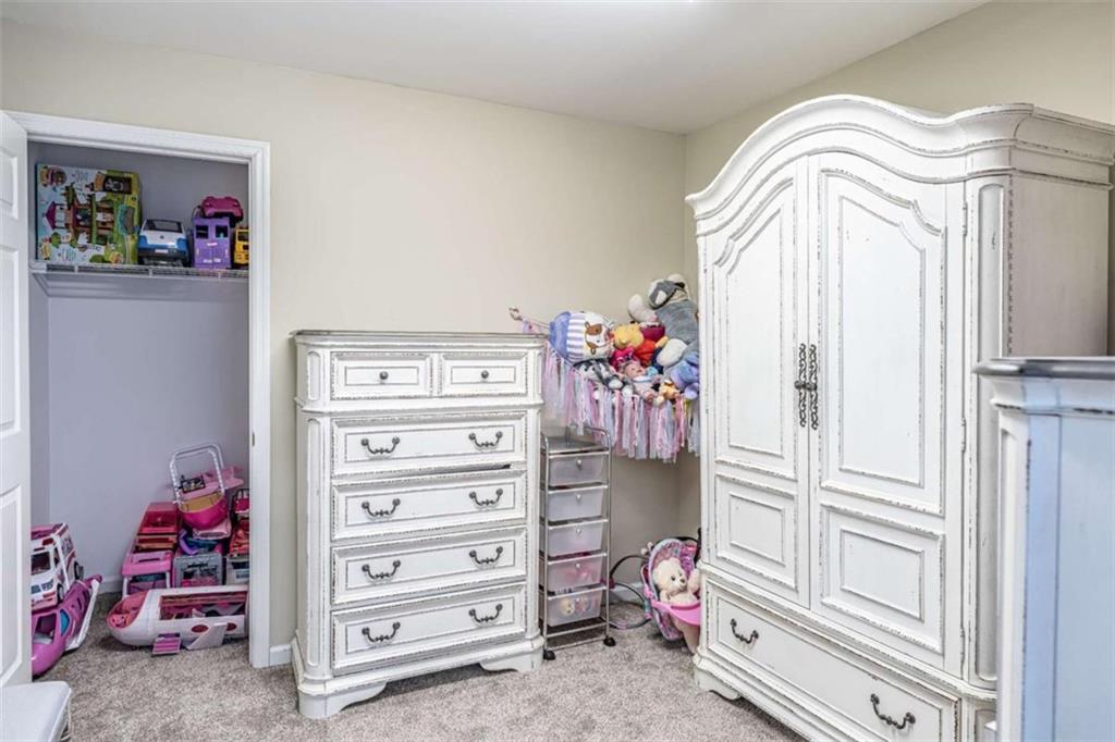 159 Ward Mountain Road Kingston, GA 30145 - Photo 32 of 75 a view of a bedroom with baby crib and cabinet