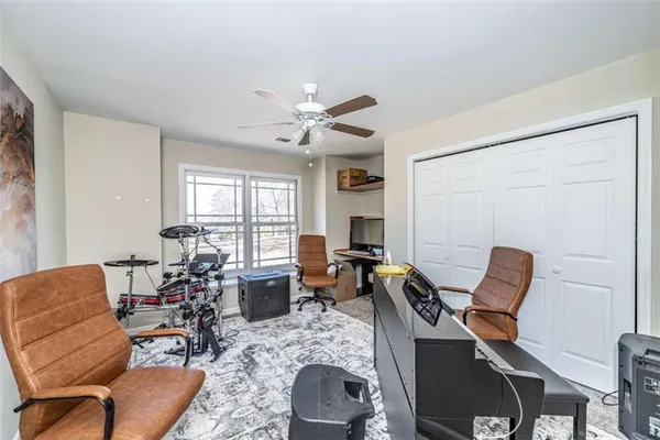 a living room with furniture and a dining table with kitchen view