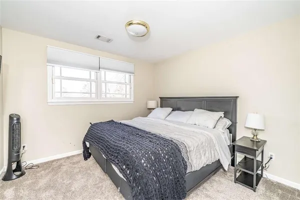 a kitchen with stainless steel appliances kitchen island granite countertop a dining table chairs and view living room