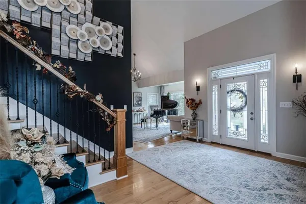 a living room with furniture a rug and a chandelier