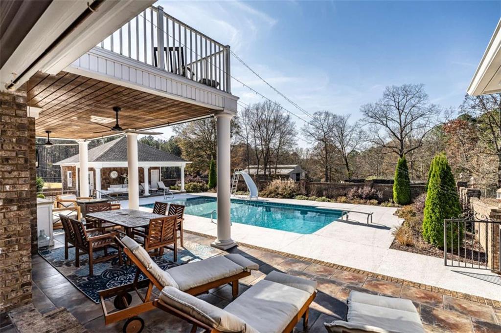 159 Ward Mountain Road Kingston, GA 30145 - Photo 63 of 75 a view of a patio with table and chairs floor to ceiling window with wooden floor