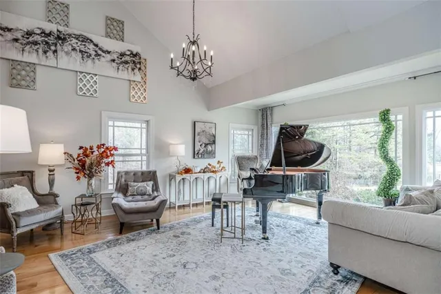 a living room with furniture a flat screen tv and a window