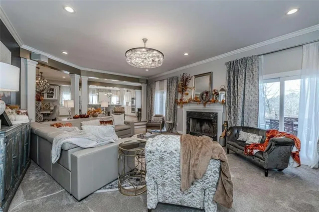 a living room with furniture kitchen view and a flat screen tv