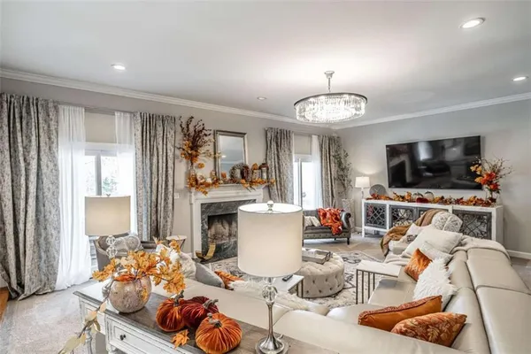a large white kitchen with a sink and cabinets