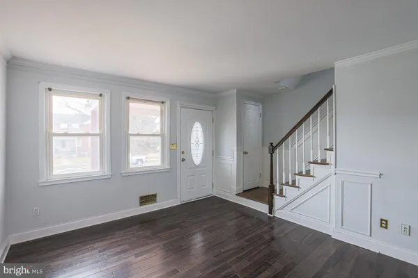 a view of an entryway with wooden floor and stairs