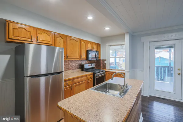 a kitchen with a sink stove and cabinets