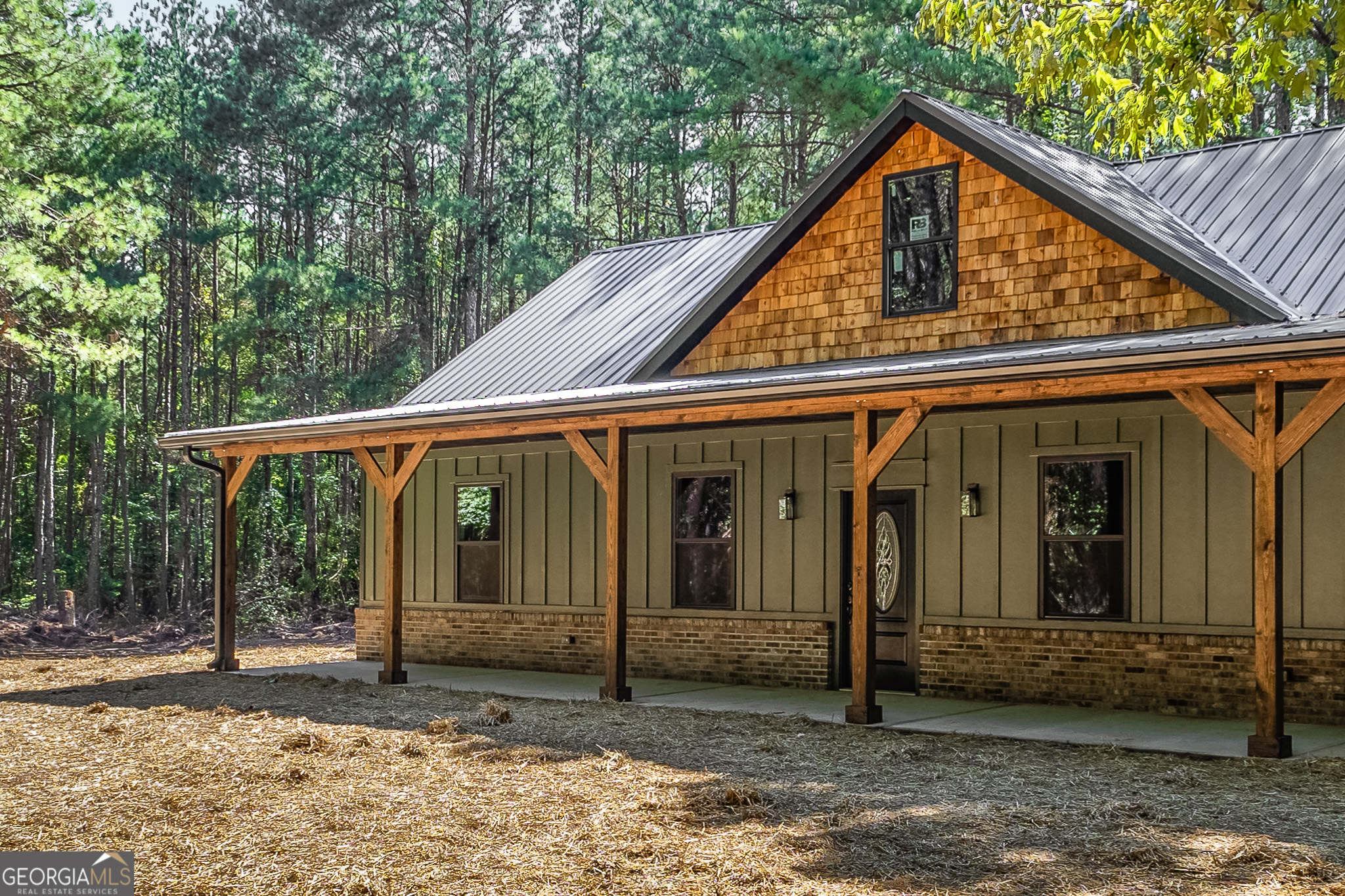 331 Loyd Smith Road Lexington, GA 30648 - Photo 1 of 1 a view of a small house with floor to ceiling window and wooden fence