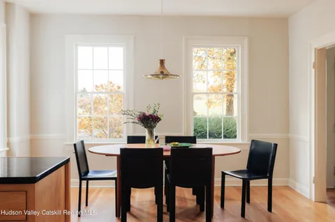 a view of a dining room with furniture and a window