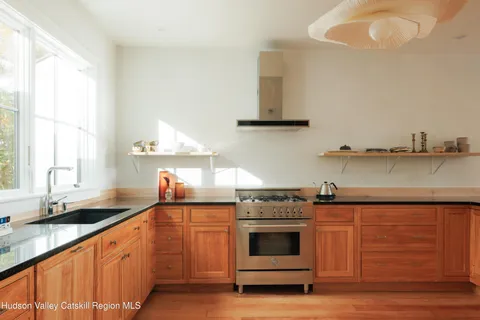 a kitchen with stainless steel appliances white cabinets and a sink
