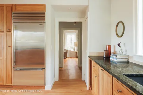 a en suite bathroom with a granite countertop sink and a mirror