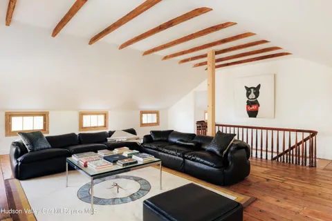 a living room with furniture a rug and a window