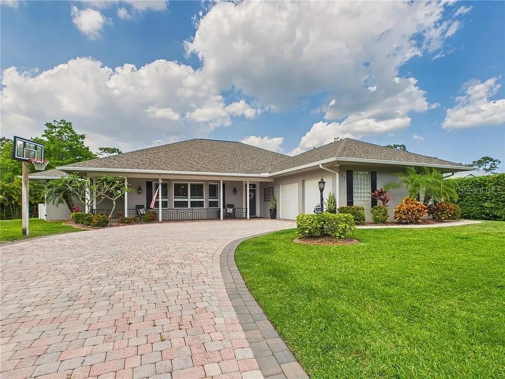 a front view of house with yard and green space