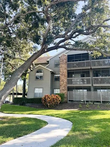 a front view of house with a garden
