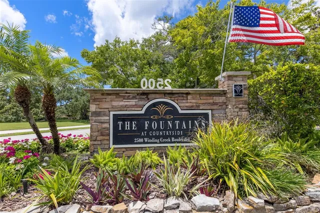 a sign that is sitting in front of flowers