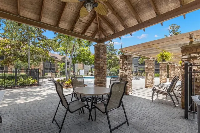 a view of a patio with a table and chairs under an umbrella