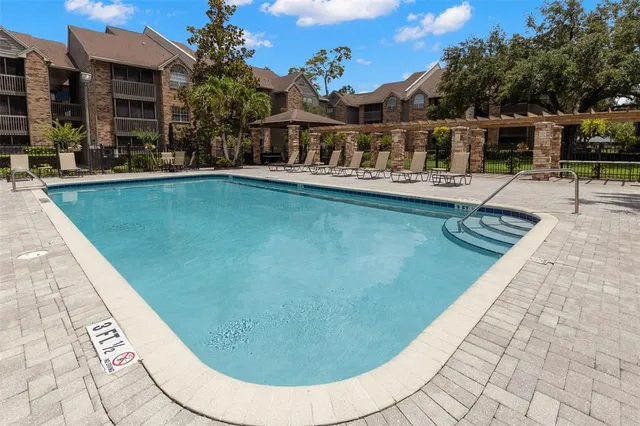 swimming pool view with a outdoor seating
