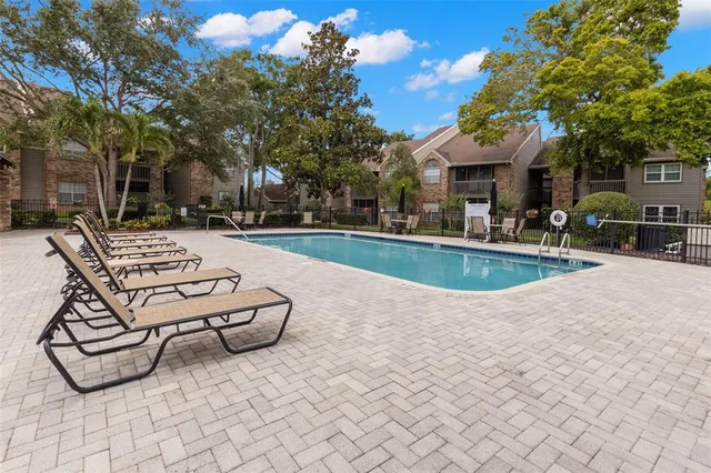 a view of patio with swimming pool table and chairs