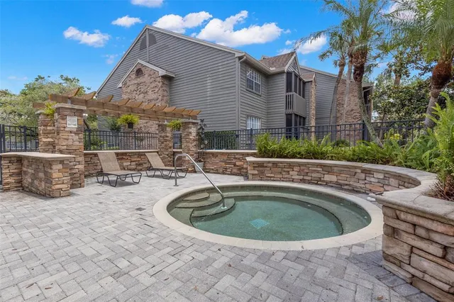 a view of a house with swimming pool and sitting area