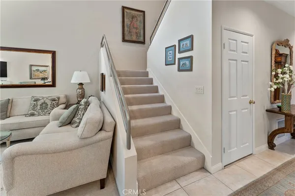 a living room with furniture and stairs