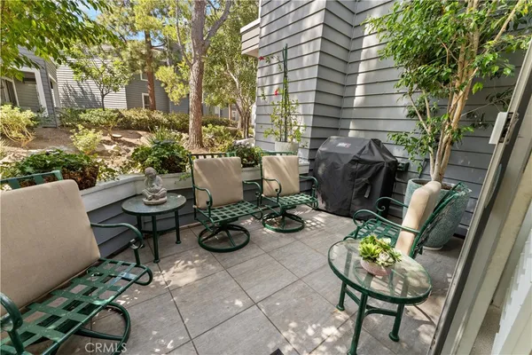 a view of a patio with couple of chairs
