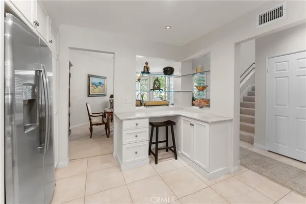 a room with furniture a rug and white walls