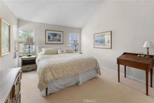 a spacious bedroom with a bed and a desk