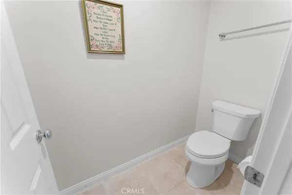 a white toilet sitting next to a shower