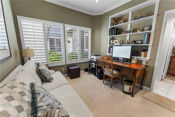 a bedroom with a bed a large window and a book shelf