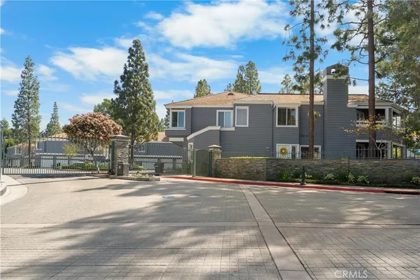 a front view of a house with a yard and trees