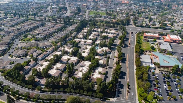 an aerial view of multiple houses with yard