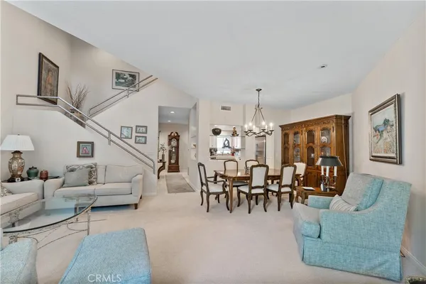 a dining room with furniture entryway and wooden floor